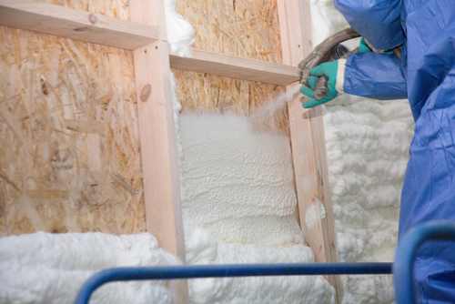 A,Man,Applies,An,Insulating,Foam,To,The,Wall,Of