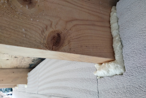 Installation,Of,Wooden,Beams,Of,Roof,Frame,With,Spray,Foam